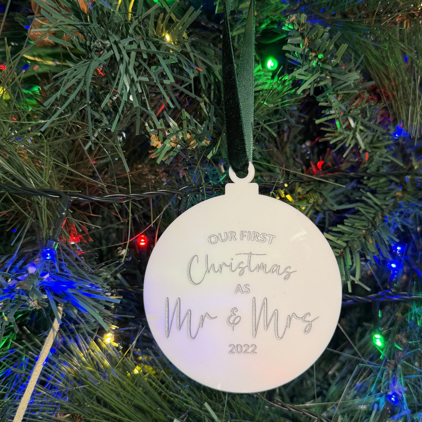 Christmas ornament on a tree with 'Our First Christmas as Mr & Mrs 2022' text
