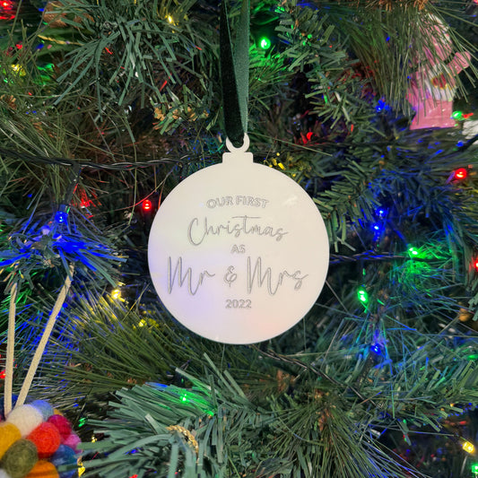 White Christmas ornament on a tree with 'Our First Christmas as Mr & Mrs 2022' text in silver